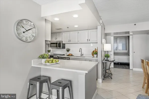 a kitchen with a table chairs and a stove top oven