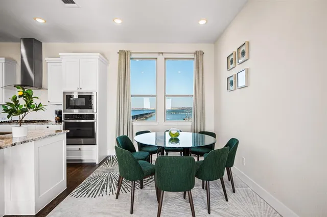 a kitchen with granite countertop cabinets a dining table and chairs