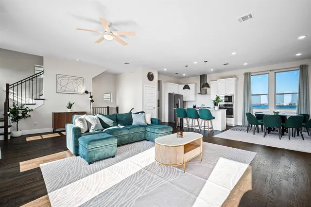 a dining room filled chandelier and wooden floor