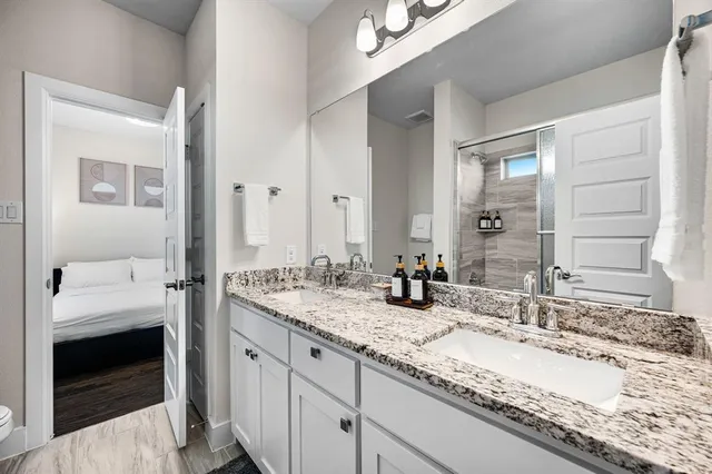 a spacious bathroom with a tub sink and mirror
