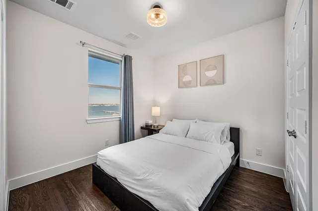 a bedroom with a bed and a night stand