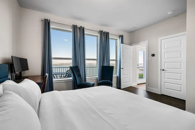 a bedroom with a large bed and a tv