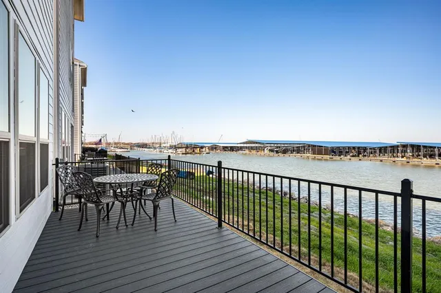 a view of a roof deck with table and chairs