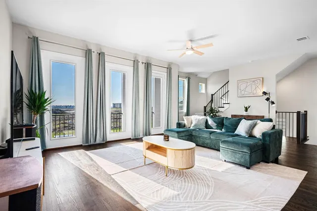 a living room with furniture and a potted plant