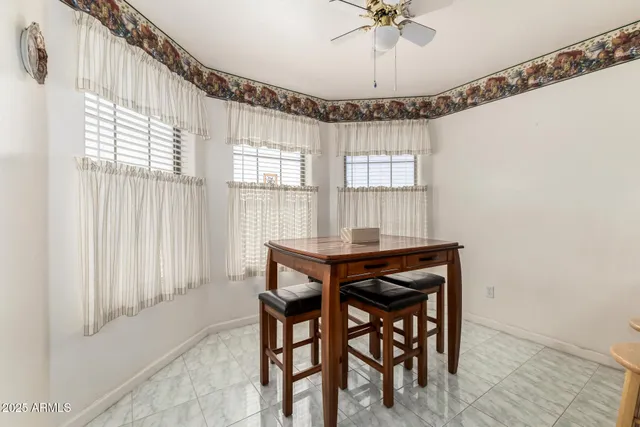 a view of a dining room with furniture and window