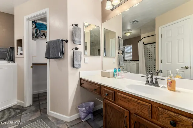 a bathroom with a sink double vanity and a mirror