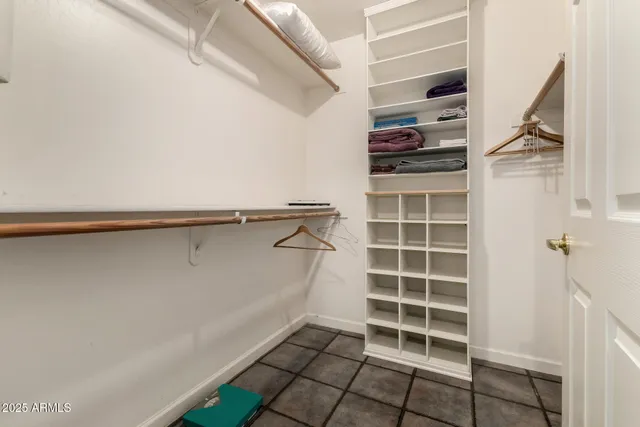 a view of walk in closet with empty racks