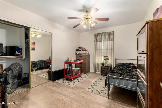 a bedroom with furniture a chandelier and a window