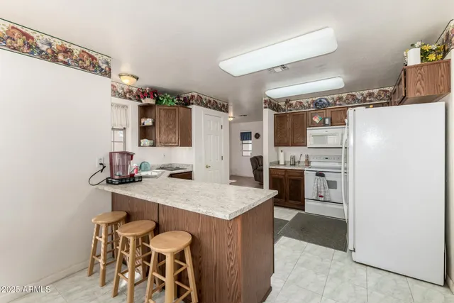 a kitchen with a sink refrigerator and cabinets