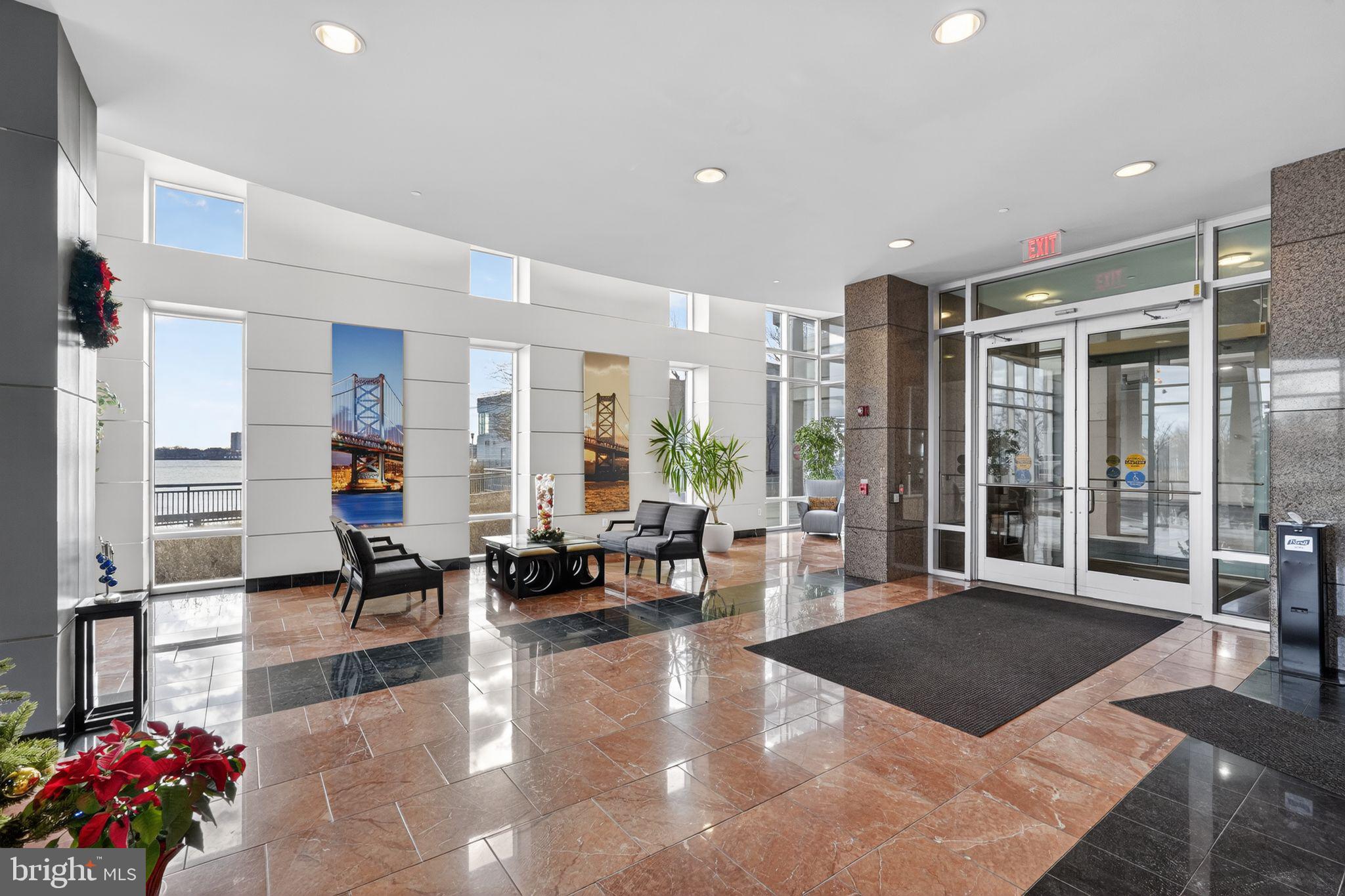 901 North Penn Street, Unit R1001 Philadelphia, PA 19123 - Photo 21 of 24 a living room with furniture large window and potted plants