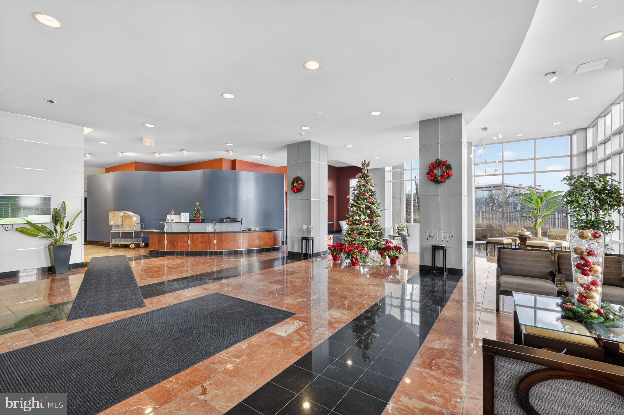 901 North Penn Street, Unit R1001 Philadelphia, PA 19123 - Photo 4 of 24 a lobby with furniture and a potted plant