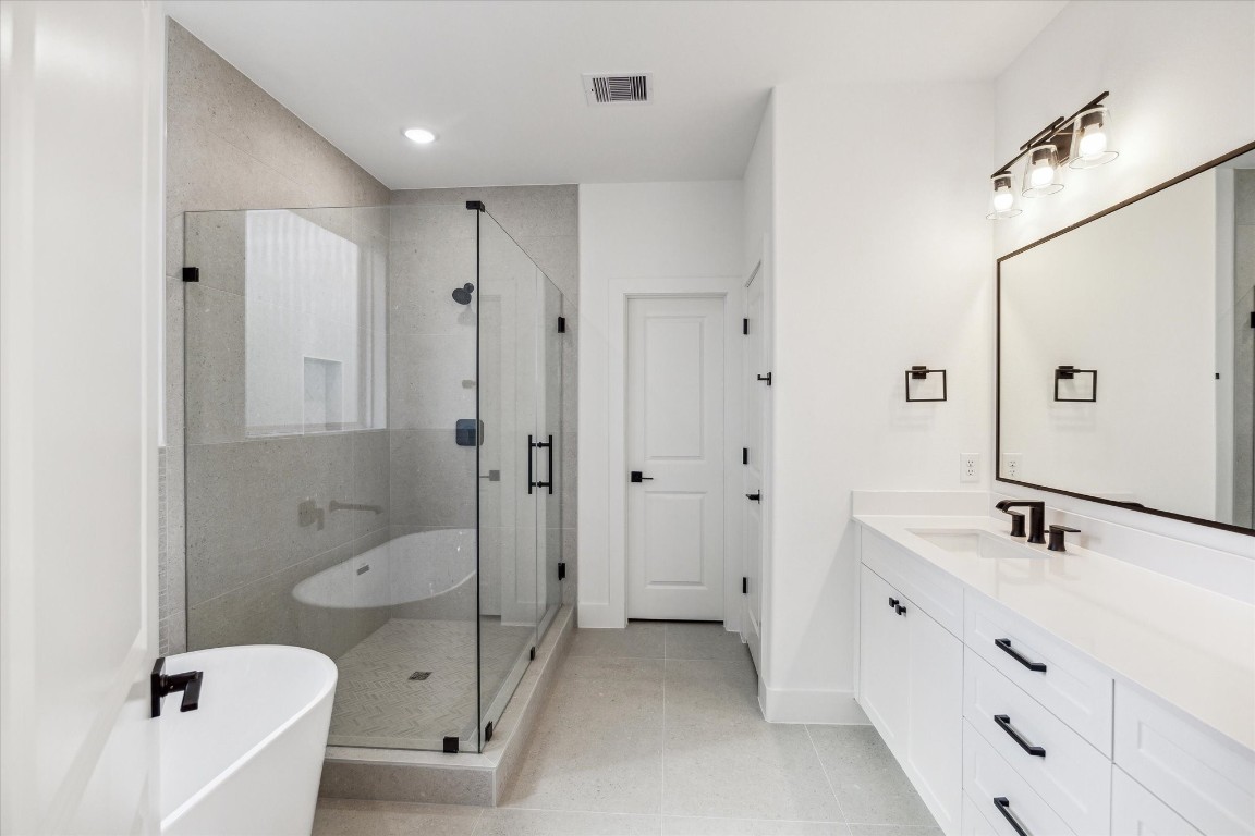 5337 Larkin Street Houston, TX 77007 - Photo 22 of 37 Relax and unwind in this spacious ceramic tub, complemented by sleek, modern wall tiles.
