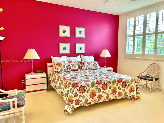 a bedroom with bed and a window