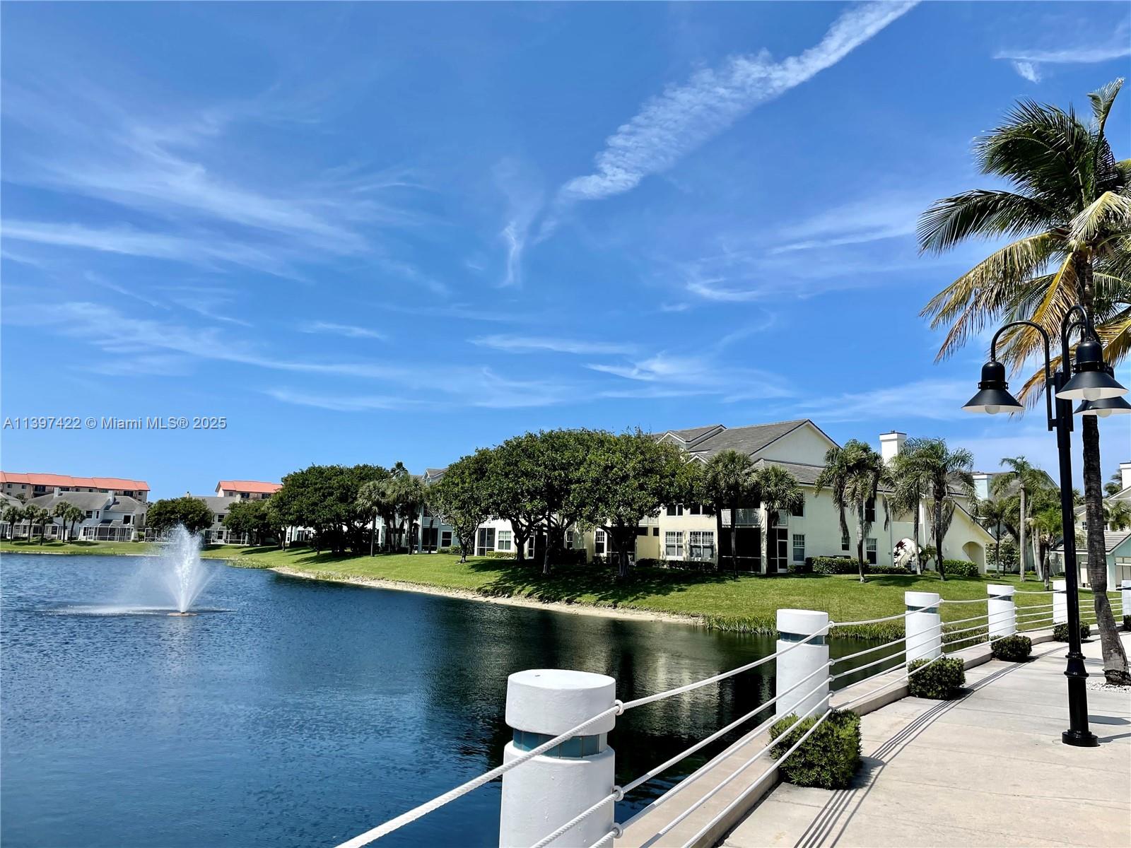 905 Mainsail Circle, Unit 905 Jupiter, FL 33477 - Photo 23 of 27 a view of a lake with a garden