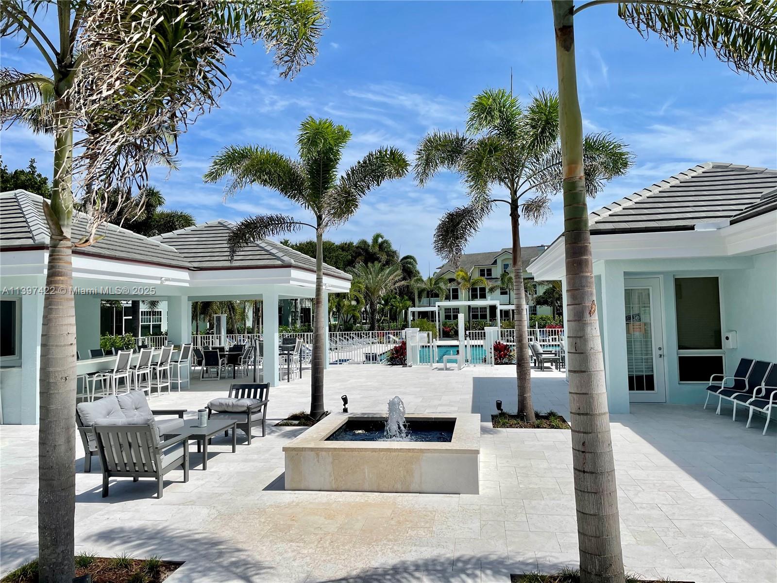905 Mainsail Circle, Unit 905 Jupiter, FL 33477 - Photo 24 of 27 a view of a patio with couches and table with potted plants