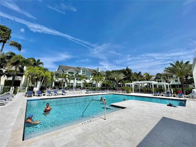 a view of swimming pool with outdoor seating and plants
