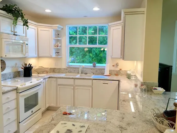a kitchen with a sink stove and wooden cabinets