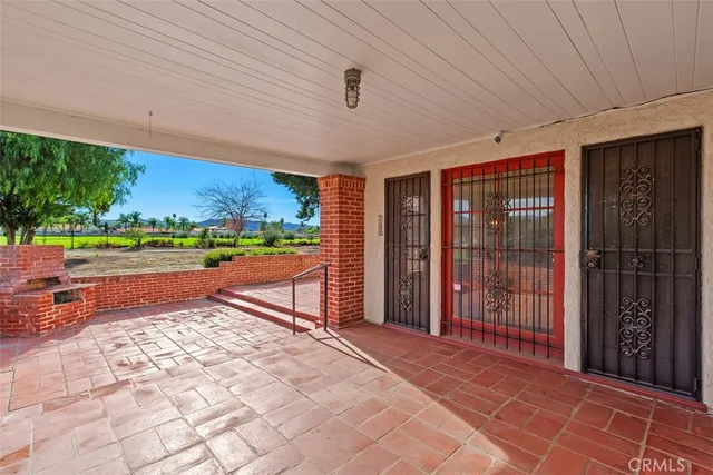a view of a house with yard and sitting area