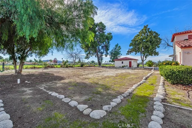 an empty room with fireplace and windows