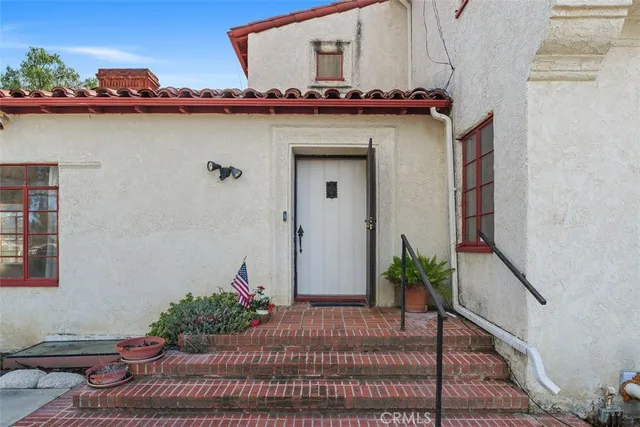 a view of a bedroom with flat screen tv and windows