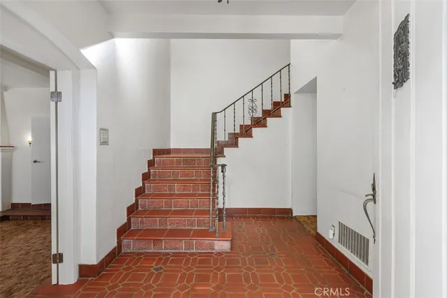 a living room with a balcony bathtub and a chandelier