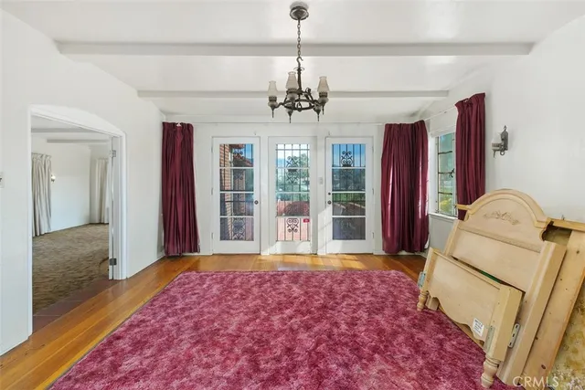 a white kitchen with a sink dishwasher white appliances and cabinets