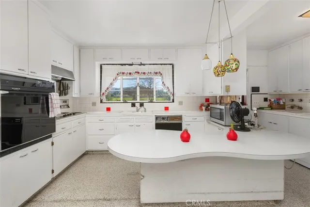 a view of a room with wooden floor and a window