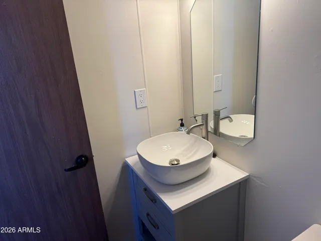 a bathroom with a sink and a mirror