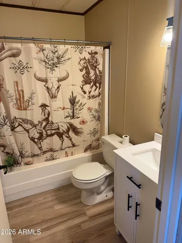 a bathroom with a toilet and a shower curtain