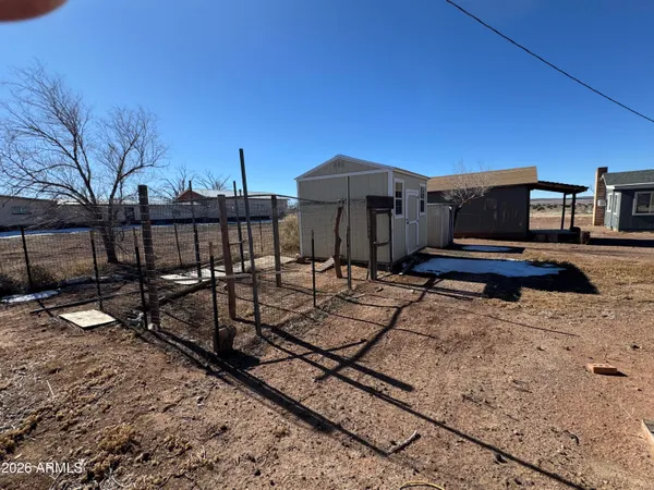 a view of a terrace with chairs and wooden fence