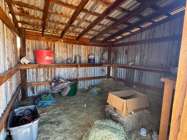 a view of a backyard with a tub and wooden chairs