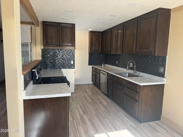 a kitchen with a sink stove and cabinets