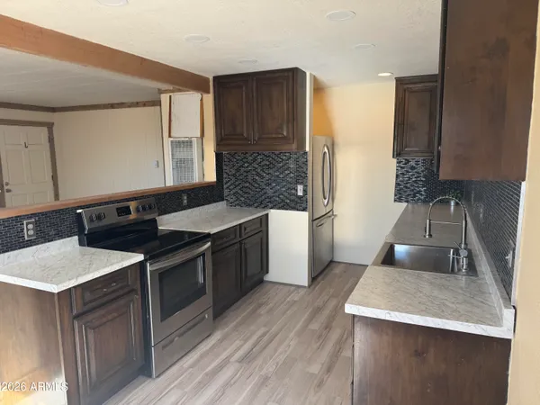a kitchen with a sink stove and cabinets
