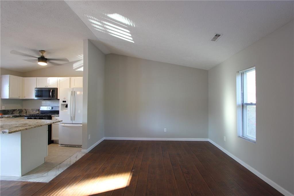 3085 Creel Road College Park, GA 30349 - Photo 3 of 38 a kitchen with granite countertop a stove a sink and a refrigerator