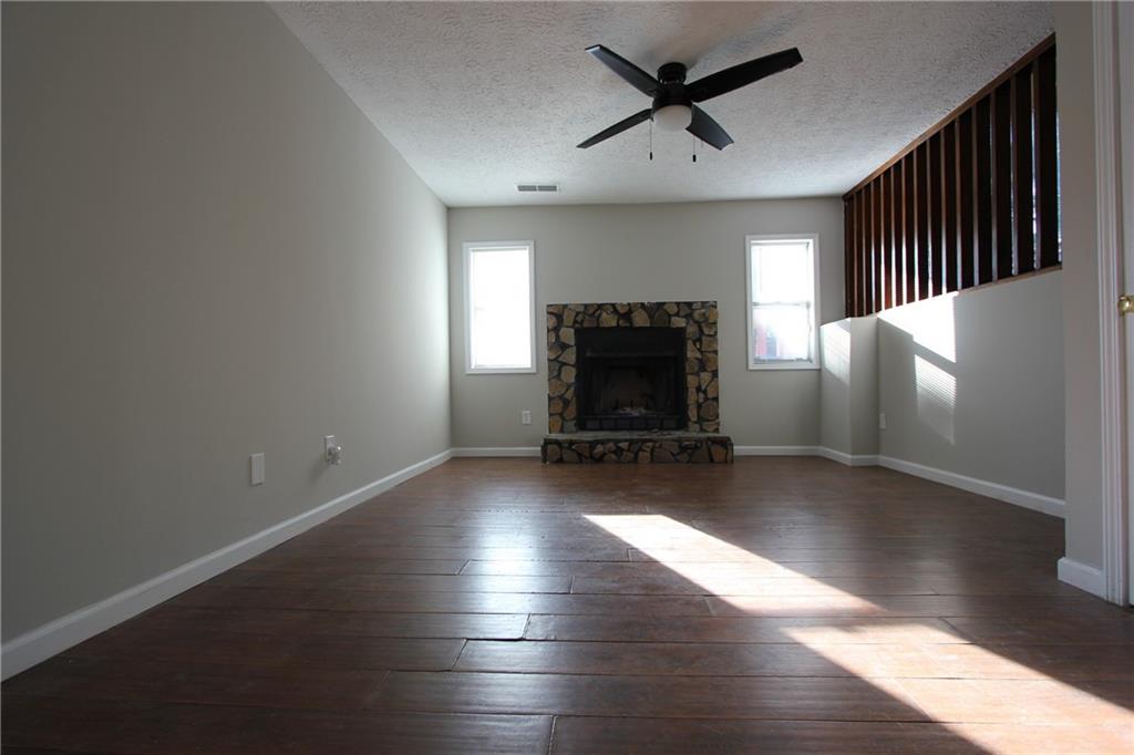 3085 Creel Road College Park, GA 30349 - Photo 4 of 38 a view of empty room with wooden floor fireplace and a window
