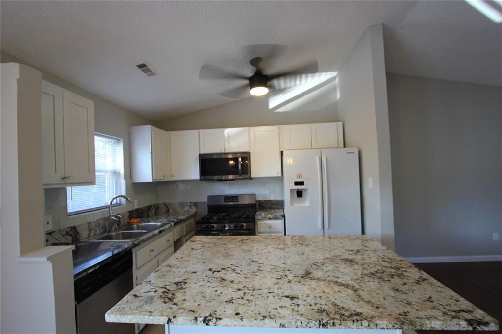 3085 Creel Road College Park, GA 30349 - Photo 8 of 38 a kitchen with stainless steel appliances granite countertop a stove refrigerator sink and dishwasher