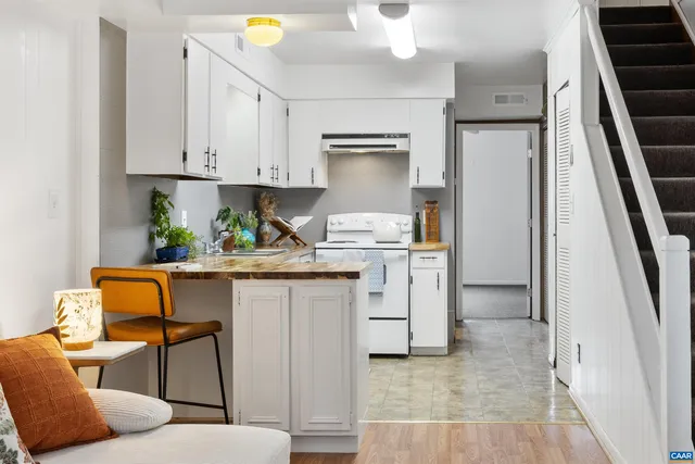 a kitchen with white cabinets and appliances