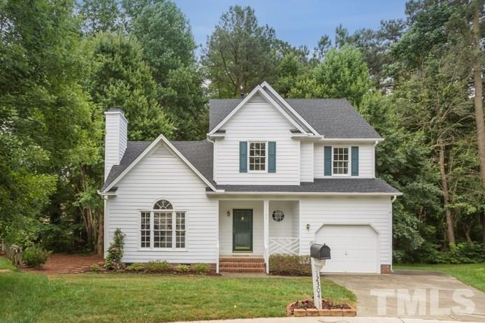 12304 Hartwick Court Raleigh, NC 27613 - Photo 1 of 14 a view of a yard in front of a house with plants and large tree
