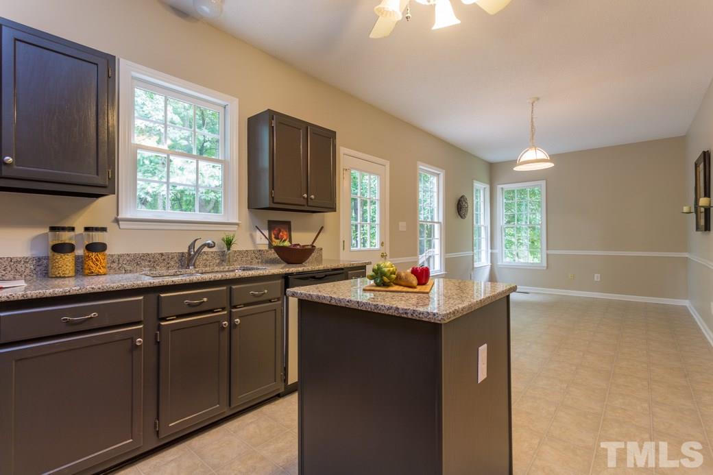 12304 Hartwick Court Raleigh, NC 27613 - Photo 2 of 14 a kitchen with sink cabinets and window