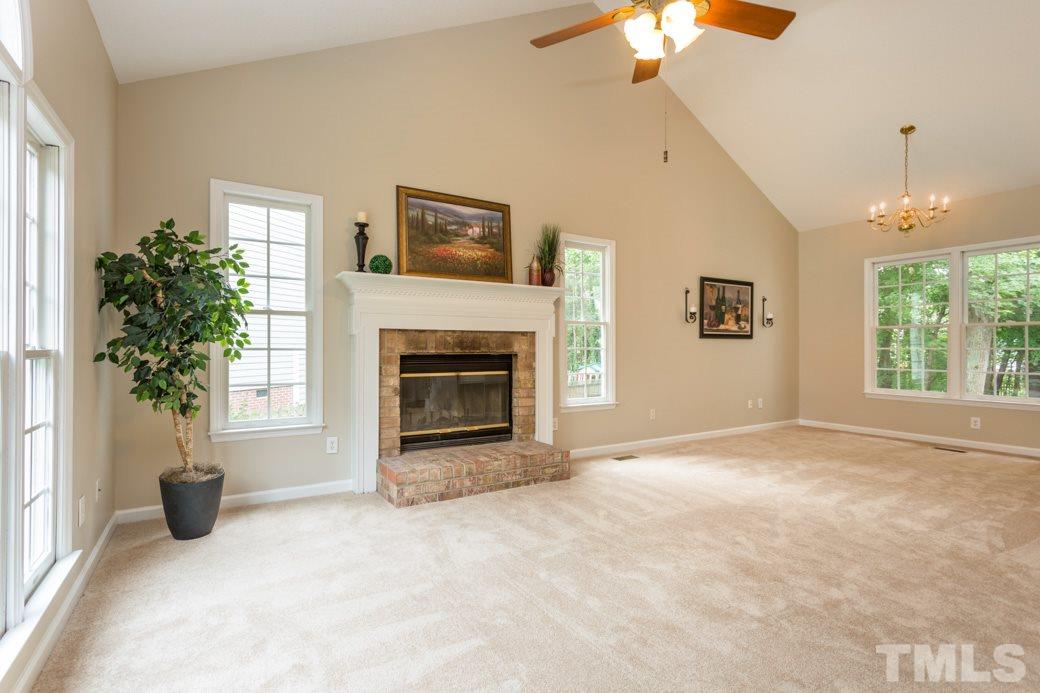 12304 Hartwick Court Raleigh, NC 27613 - Photo 4 of 14 a view of empty room with a fireplace and potted plants