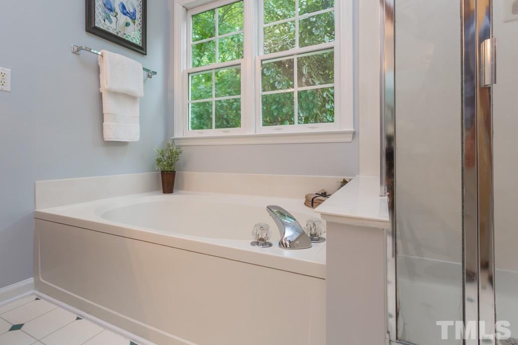 12304 Hartwick Court Raleigh, NC 27613 - Photo 10 of 14 a white bath tub sitting next to a window