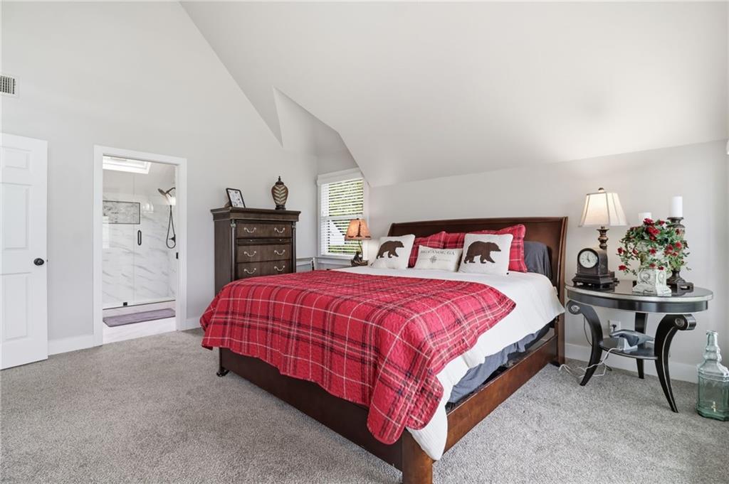 59 Falcon Heights Jasper, GA 30143 - Photo 27 of 47 a spacious bedroom with a bed and a fireplace