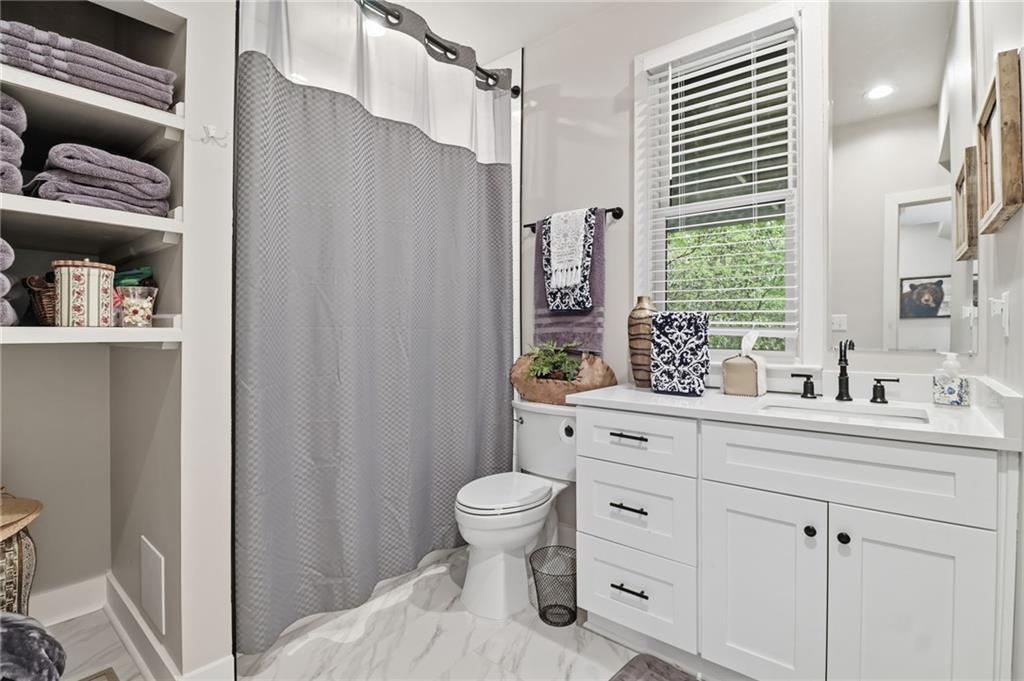 59 Falcon Heights Jasper, GA 30143 - Photo 38 of 47 a spacious bathroom with a double vanity sink toilet and a shower