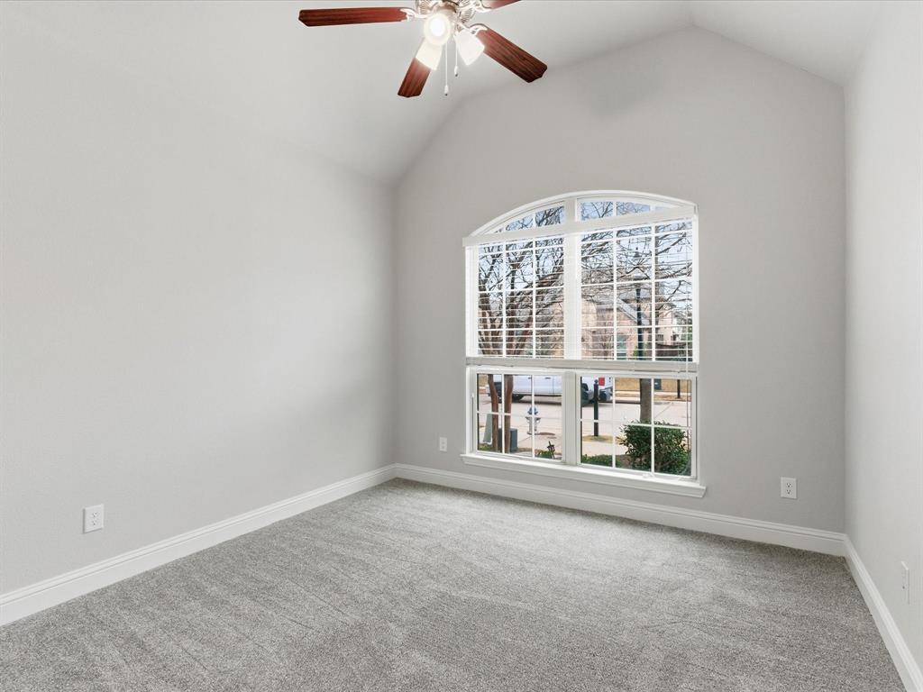 2217 Commons Way Prosper, TX 75078 - Photo 21 of 37 Unfurnished room featuring light carpet, vaulted ceiling, and a ceiling fan
