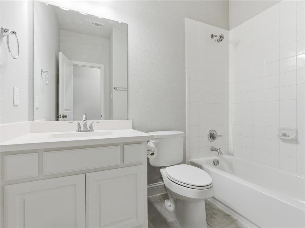 2217 Commons Way Prosper, TX 75078 - Photo 25 of 37 Bathroom with tub / shower combination, vanity, and a textured wall