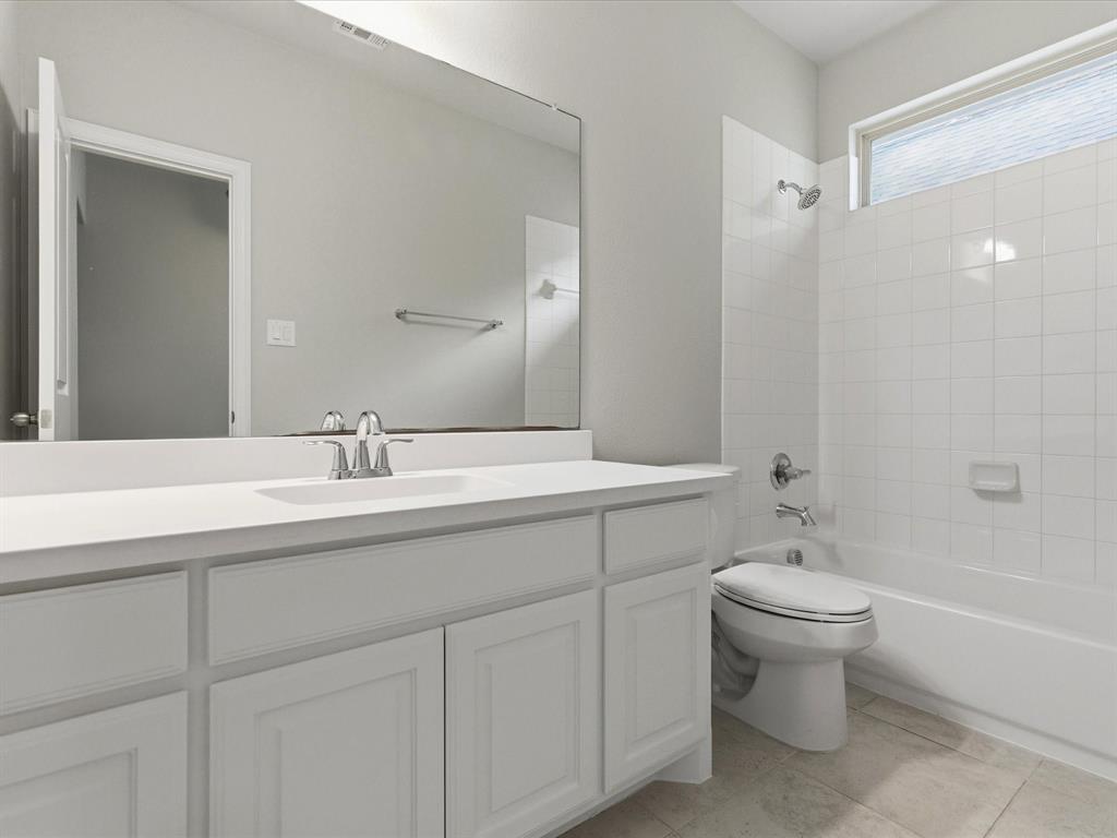 2217 Commons Way Prosper, TX 75078 - Photo 29 of 37 Bathroom featuring vanity, bathtub / shower combination, and light tile patterned flooring