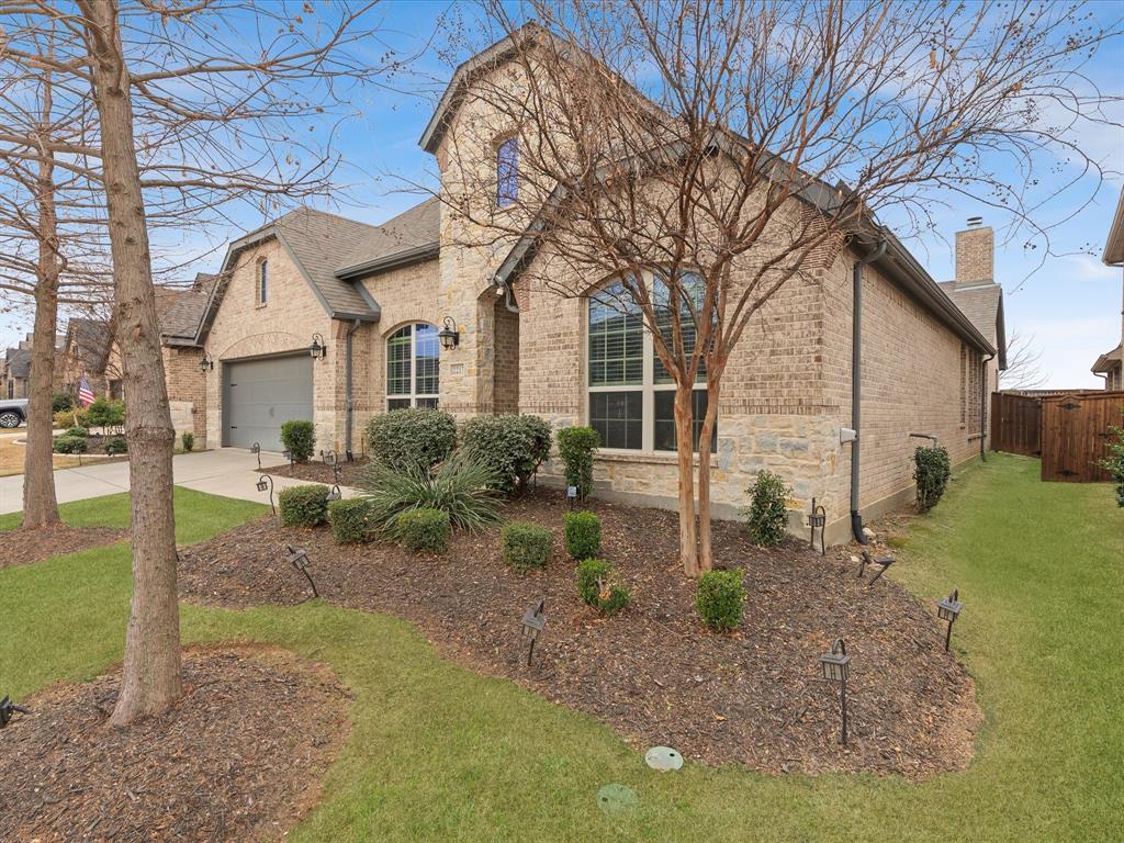 2217 Commons Way Prosper, TX 75078 - Photo 3 of 37 French country inspired facade with brick siding, concrete driveway, a garage, and a chimney