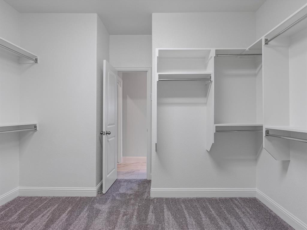 2217 Commons Way Prosper, TX 75078 - Photo 33 of 37 Spacious closet with dark colored carpet