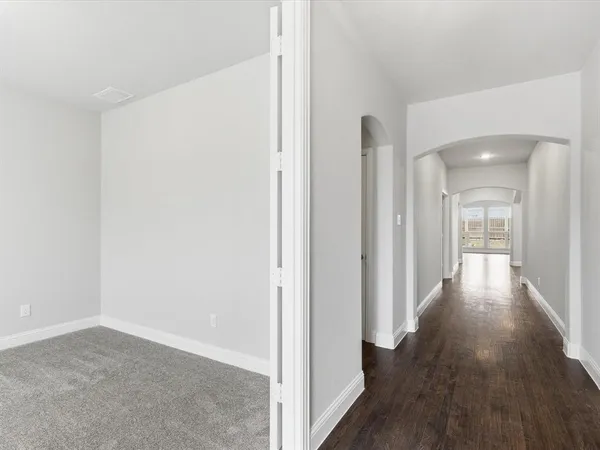 a view of a hallway with wooden floor
