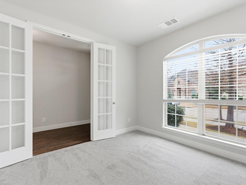 2217 Commons Way Prosper, TX 75078 - Photo 9 of 37 Carpeted empty room with french doors and baseboards